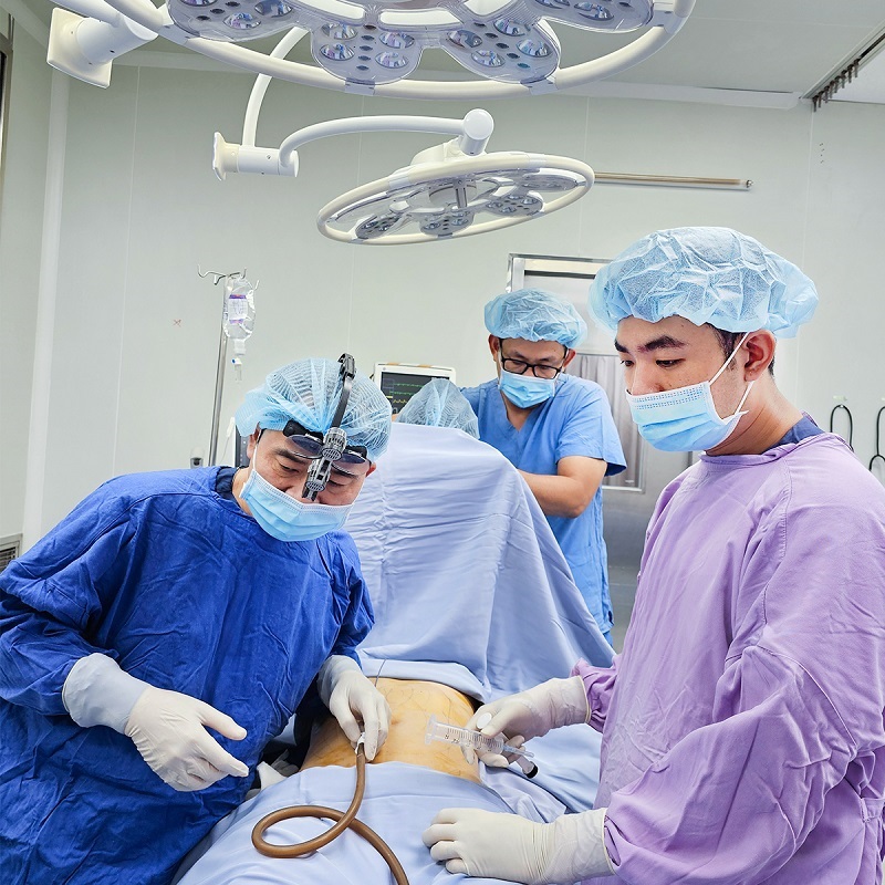 The doctor ensures the patient's safety during the surgical procedure.