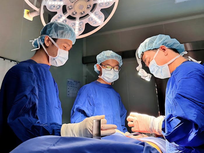 A close-up of the Lipo 360 ultrasonic liposuction procedure in a sterile, medical-standard operating room.