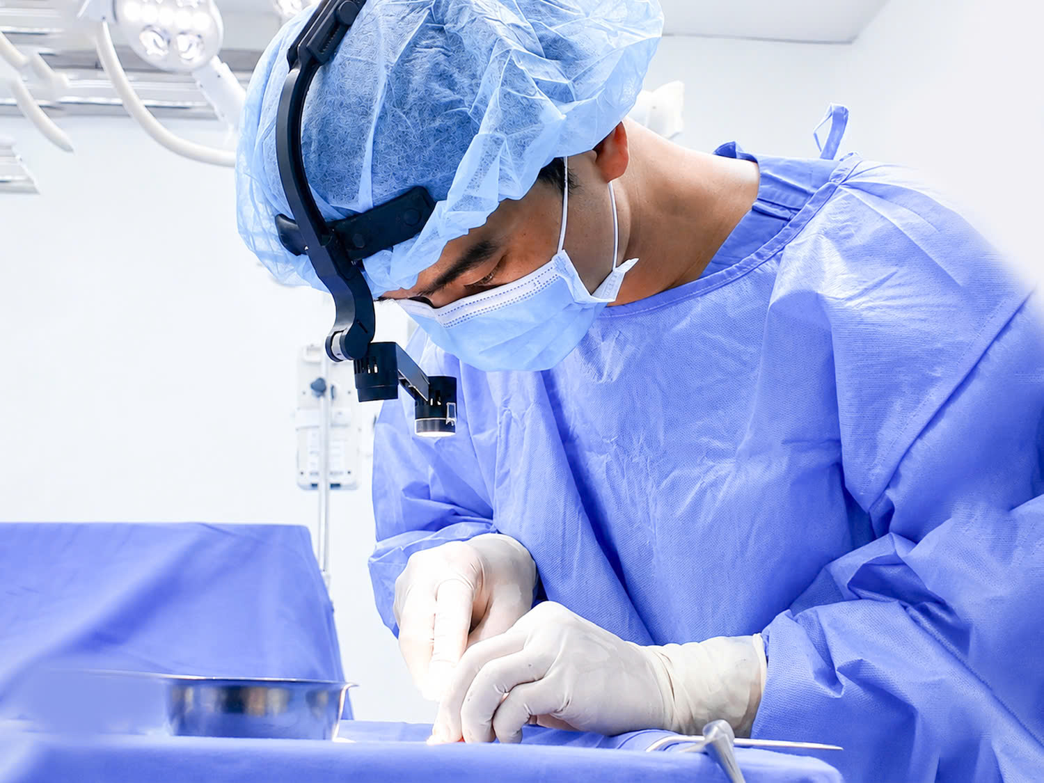 Dr. Louis Truong carves rib cartilage to shape the nasal bridge and tip.